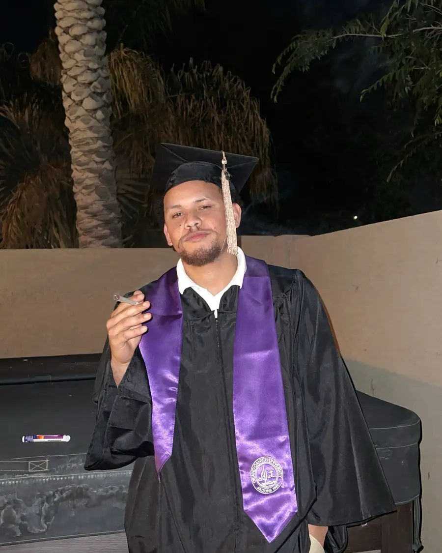 Coach Cal in graduation cap and gown with purple honors stole — college grad, Bay Area independent artist