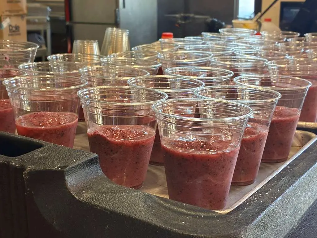 Organic Blendz berry smoothie cups lined up for service — real-fruit smoothie line by Coach Cal